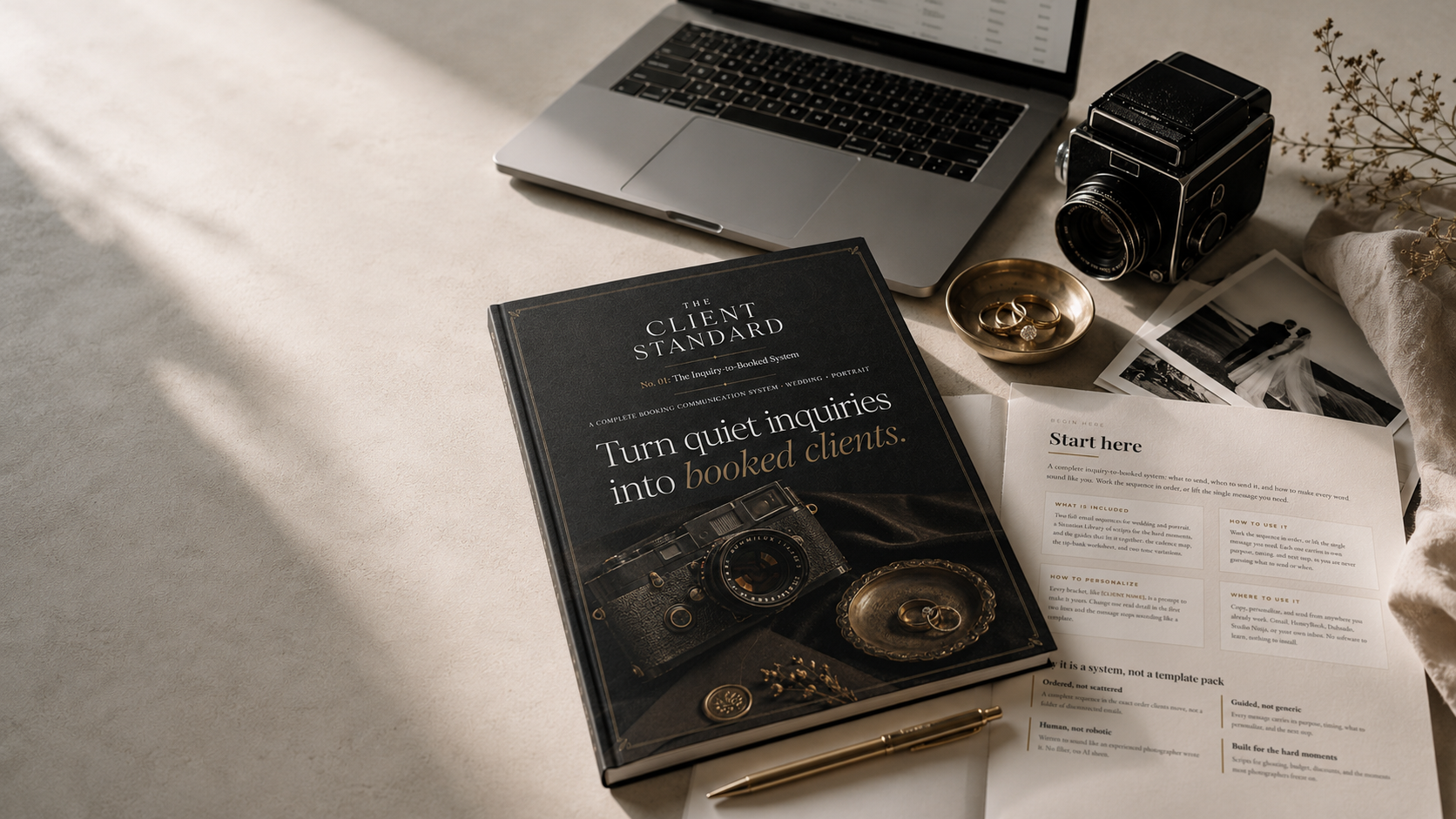 The Client Standard, styled as a keepsake edition on a desk with an open interior page, a vintage camera, and wedding photo prints