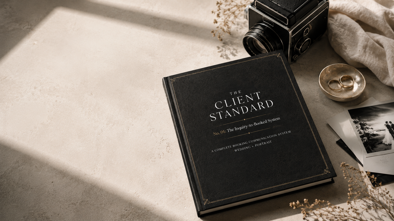 The Client Standard: The Inquiry-to-Booked System, styled as a keepsake edition, with a vintage camera and brass ring dish